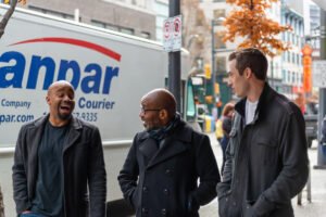 Three men talking on the streets of Vancouver