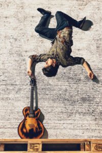 Upside-down musician with guitar