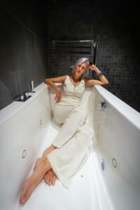 Woman with grey hair in bathtub